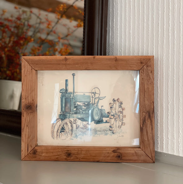 Framed Print of Old Blue Tractor